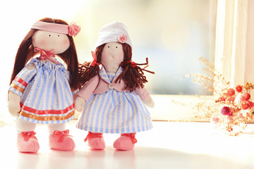 Handmade doll near window close-up