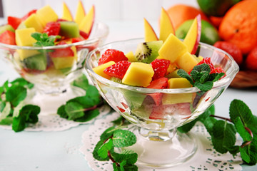 Fruit salad with mint in glassware