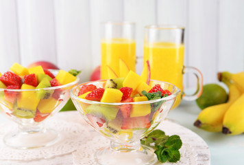 Fruit salad with mint and orange juice in glassware