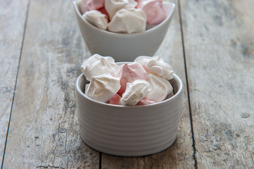 Meringue cookies in bowl close up