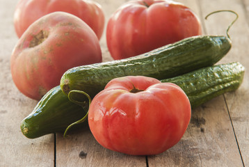 Fresh Tomatoes and cucumber close up on white