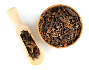 Clove spice in wooden bowl, isolated on white