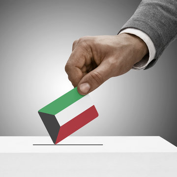 Black male holding flag. Voting concept - Kuwait