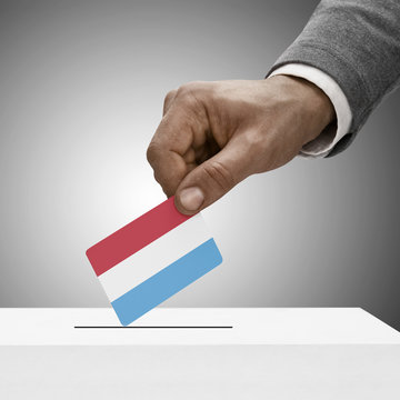 Black male holding flag. Voting concept - Luxembourg