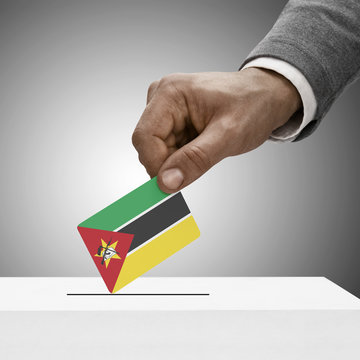 Black male holding flag. Voting concept - Mozambique