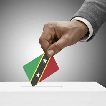 Black male holding flag. Voting concept - Saint Kitts and Nevis