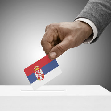 Black male holding flag. Voting concept - Serbia