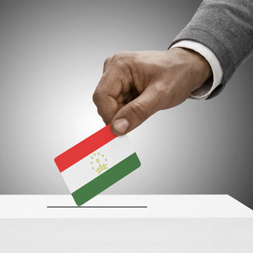 Black male holding flag. Voting concept - Tajikistan