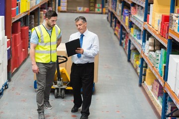 Warehouse worker talking with his manager
