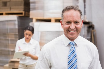 Warehouse manager smiling at camera