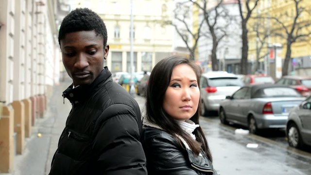 Unhappy couple are offended - black man and asian woman - street