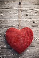 Red burlap heart on vintage table