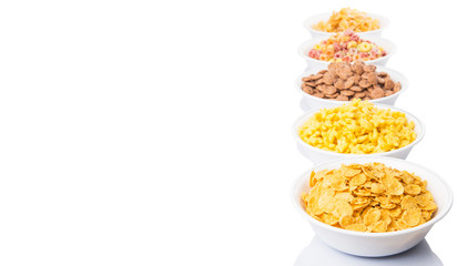 Mix variety of breakfast cereal in white bowls 