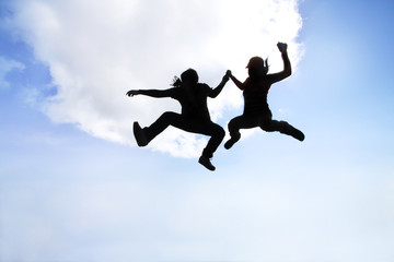 Fototapeta na wymiar silhouette of women and man jump to the sky