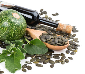 Glass bottle of Pumpkin Seed Oil, pumkin and peeled pumpkin see