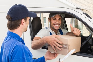 Delivery driver handing parcel to customer in his van