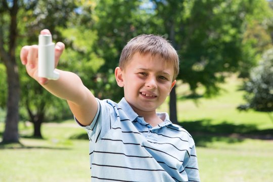 Little boy showing his inhaler