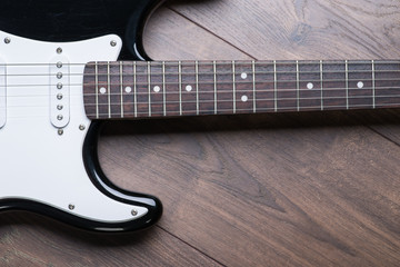 Electric guitar on a brown wooden floor