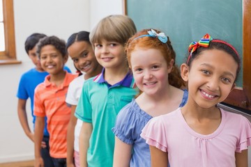 Fototapeta na wymiar Smiling pupils in classroom