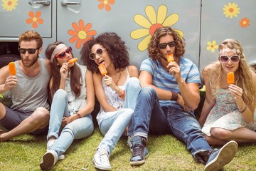 Hipster friends enjoying ice lollies