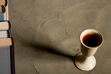 chalice of wine with books