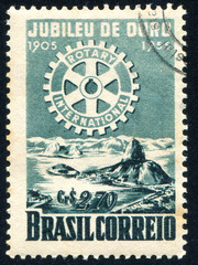 Naklejka premium Rotary Emblemo and Bay of Rio de Janeiro