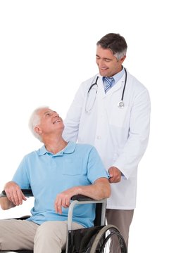 Doctor pushing senior patient in wheelchair