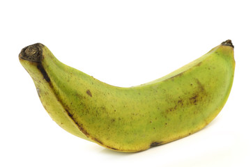 fresh still unripe plantain (baking) banana on a white backgroun © tpzijl