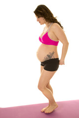 Fototapeta premium pregnant woman fitness outfit stand side