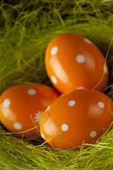 Orange Easter eggs in the nest