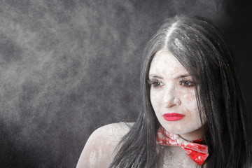 Portrait of a woman in a cloud of white powder