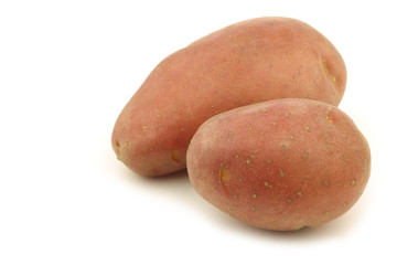 some whole red small potatoes on a white background