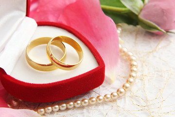 pair of wedding rings with roses for background image