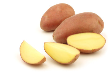 red small potatoes and some pieces on a white background