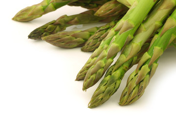  fresh green asparagus shoots on a white background