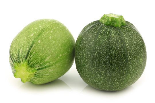 one light green and a green round zucchini cut zucchini