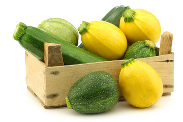 yellow and green zucchini (Cucurbita pepo) in a wooden crate
