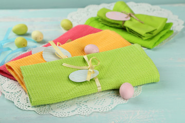 Napkins with Easter decorations  on color wooden background