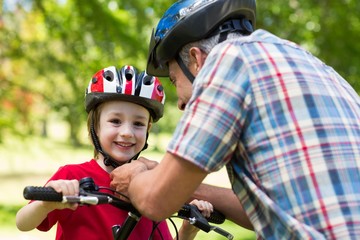 Father attaching his sons cycling helmet