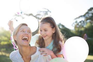 Happy mother playing with her daughter