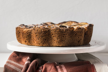 Homemade apple pie over a rustic white shelves