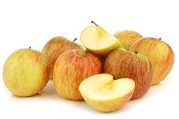 fresh "Fuji" apples and some pieces on a white background