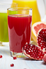 Glasses with fresh vegetable juices isolated on white table. Det