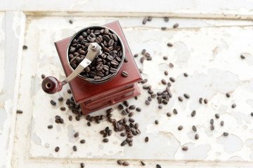 Old-fashioned coffee grinder with coffee beans