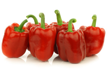 fresh red bell peppers (capsicum) on a white background