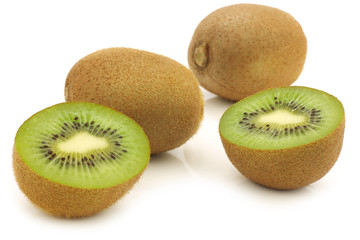 fresh kiwi fruit and a cut one on a white background