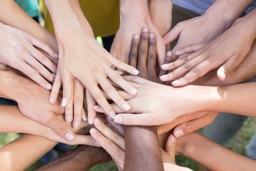 Friends putting their hands together