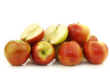 bunch of braeburn apples and a cut one on a white background