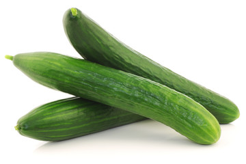 bunch of fresh cucumbers on a white background