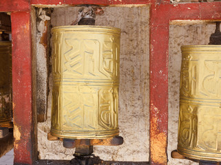 Gold colored Buddhist prayer wheel in Lhasa, Tibet